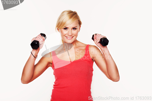 Image of Fit woman lifting dumbbells