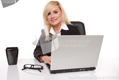 Image of Efficient businesswoman working on her laptop