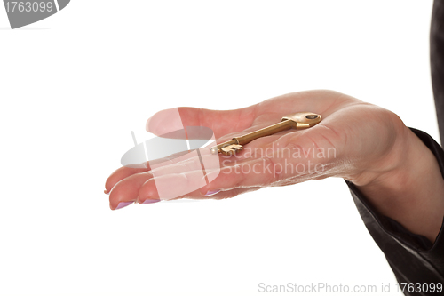 Image of Female hand displaying a brass key