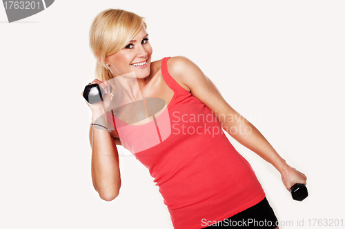 Image of Fit woman lifting dumbbells