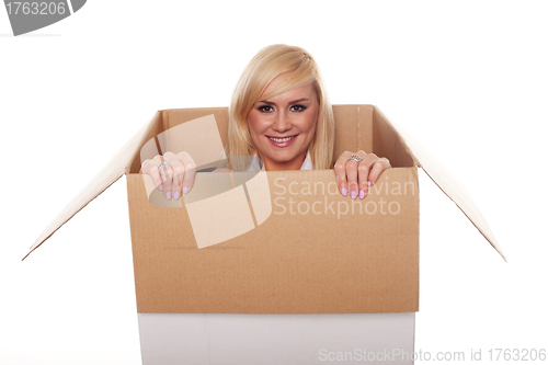 Image of Attractive young blonde emerging from a box