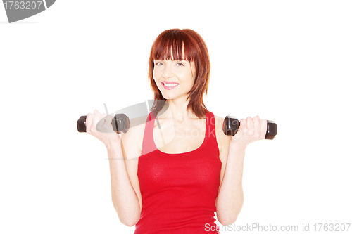 Image of Attractive readhead female lifting weights