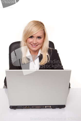 Image of Smiling secretary at her laptop