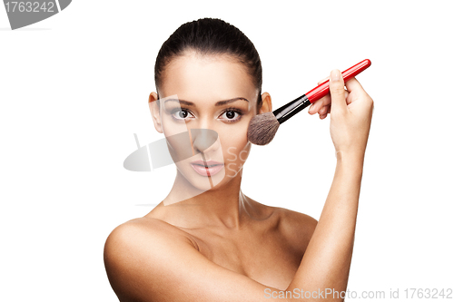Image of Young beautiful woman applying makeup