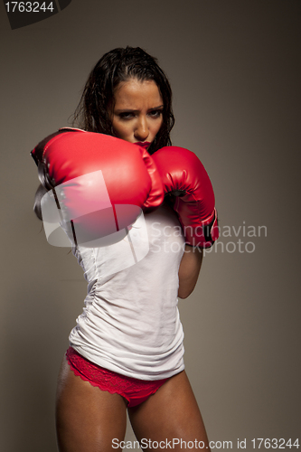 Image of Athletic woman boxer throwing a punch