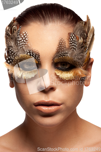 Image of Woman wearing creative feather make-up