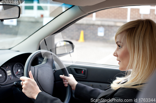 Image of Beautiful businesswoman driving a car