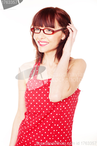 Image of red haired woman wearing red dress with polka dots