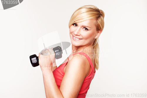 Image of Pretty girl keeping her beautiful shape exercising