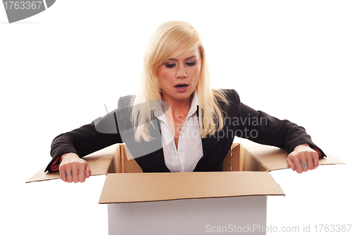 Image of Scared young blonde getting out from a box