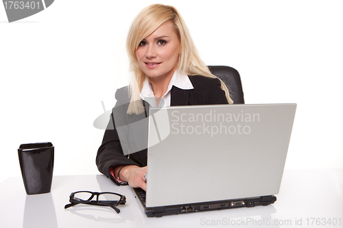 Image of Efficient businesswoman working on her laptop