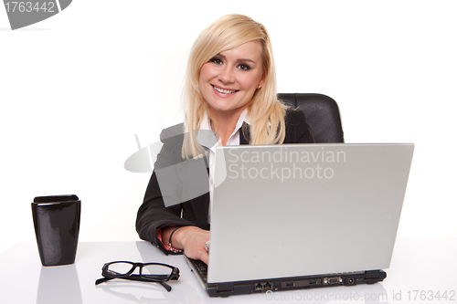 Image of Efficient businesswoman working on her laptop