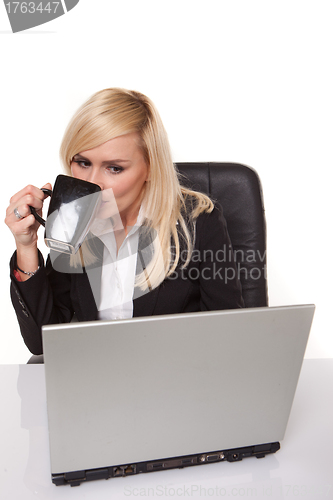 Image of Efficient businesswoman working on her laptop
