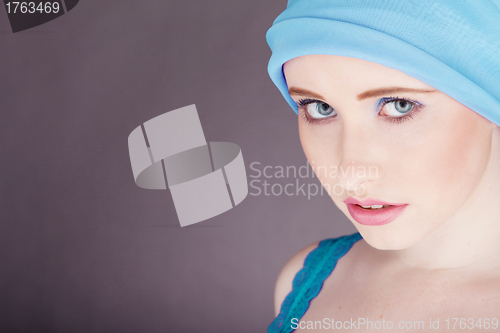 Image of woman with blue fabric wrapped around head