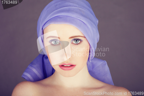 Image of woman with blue fabric wrapped around head