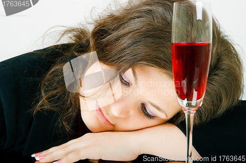 Image of Sleeping girl and a glass of wine