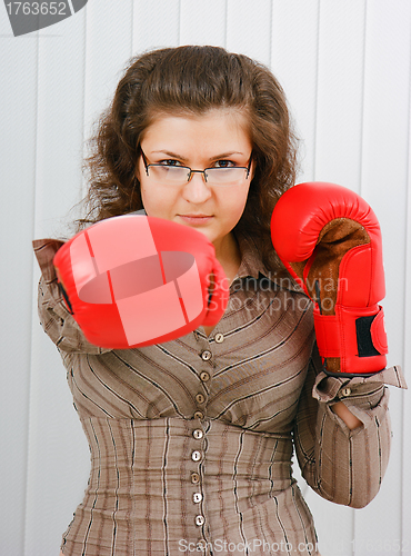 Image of Business woman with boxing gloves