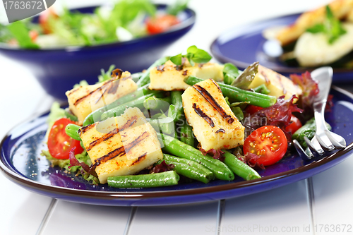 Image of Grilled cheese on green beans with tomatoes