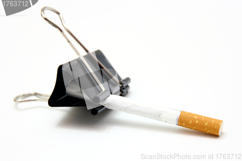 Image of broken cigarettes  metal clip