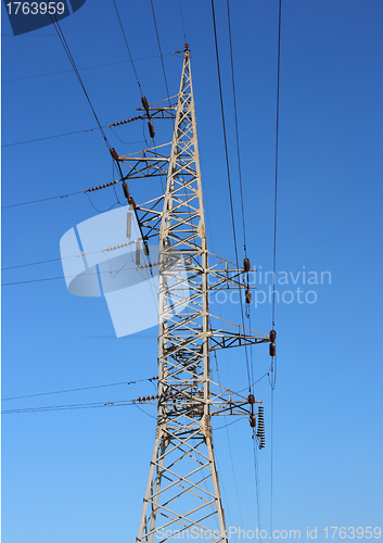 Image of high voltage post against the blue sky