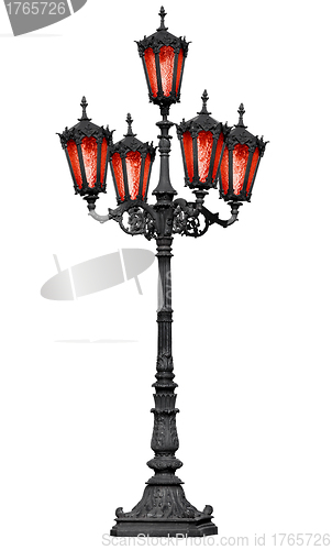 Image of Old cast iron lamp post with red glass