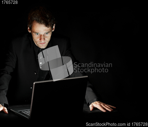 Image of Hacker with laptop in dark room