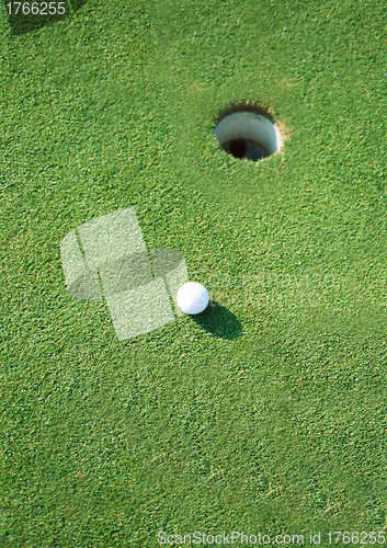 Image of golf ball hole on a field