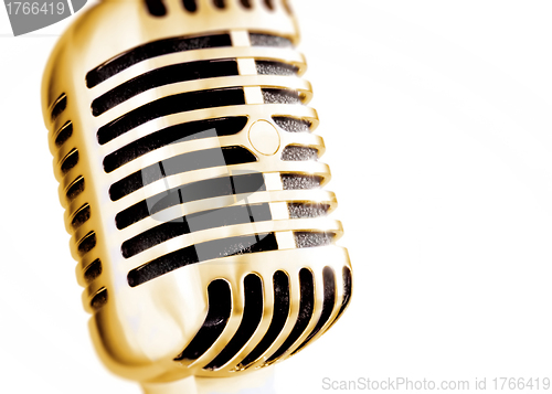 Image of golden vintage microphone isolated on white background