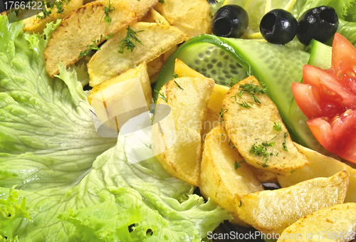 Image of Fried fish with new potatoes, tomatoes, lettuce