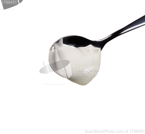 Image of spoon with yogurt.