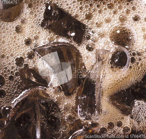 Image of cola with ice cubes close up