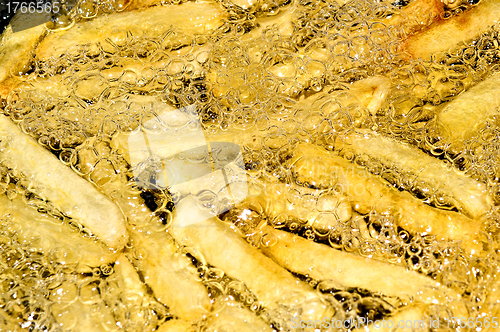 Image of French fries frying in hot oil