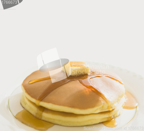 Image of Golden pancakes with butter and warm maple syrup