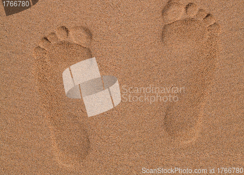 Image of Two Footprints in sand at the Beach