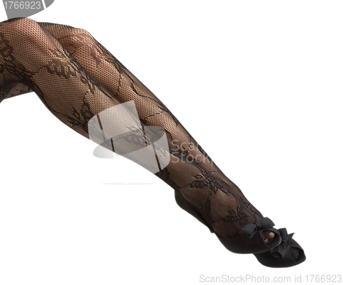 Image of Close-up of young woman's legs in high-heeled black shoes
