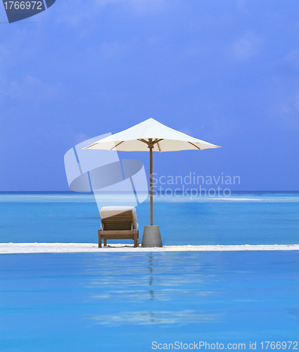 Image of beach Chairs and Umbrella on a beautiful island