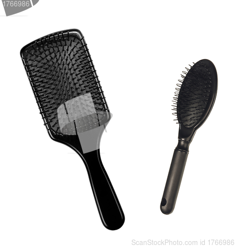 Image of two hairbrushes , comb on bright background