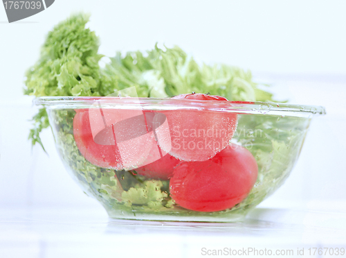 Image of fresh tomatoes with pouring water