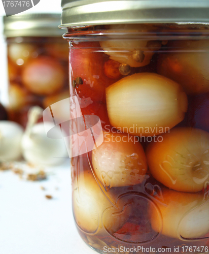 Image of Two jars with onions up close