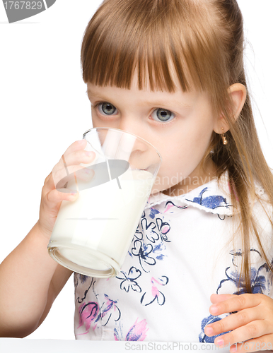 Image of Cute little girl drinks milk