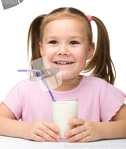 Image of Cute little girl with a glass of milk