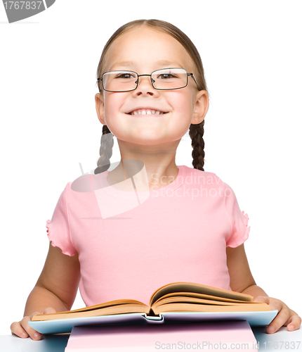 Image of Cute little schoolgirl with a book