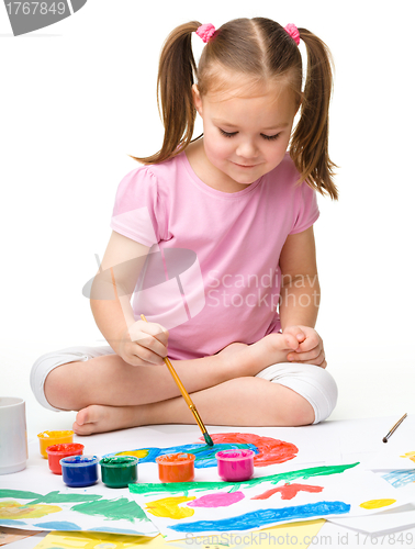 Image of Cute cheerful child play with paints