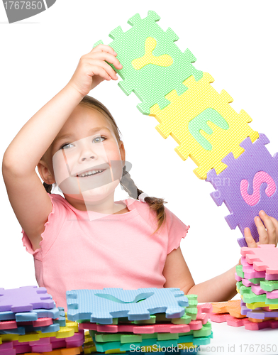 Image of Cute little girl is holding Yes slogan