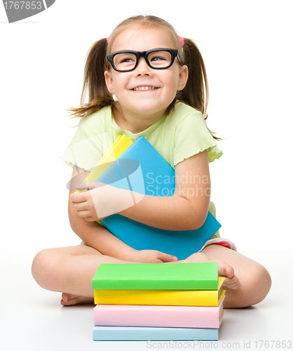 Image of Cute little girl with books