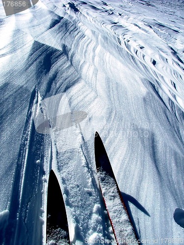 Image of skis on wind sculpted snow