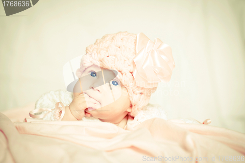 Image of baby girl in a pink hat