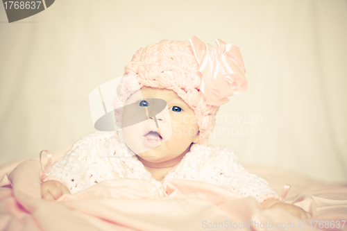 Image of baby girl in a pink hat