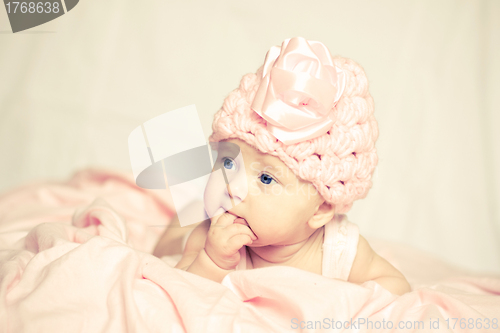 Image of baby girl in a pink hat