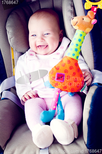 Image of baby girl smile in carseat